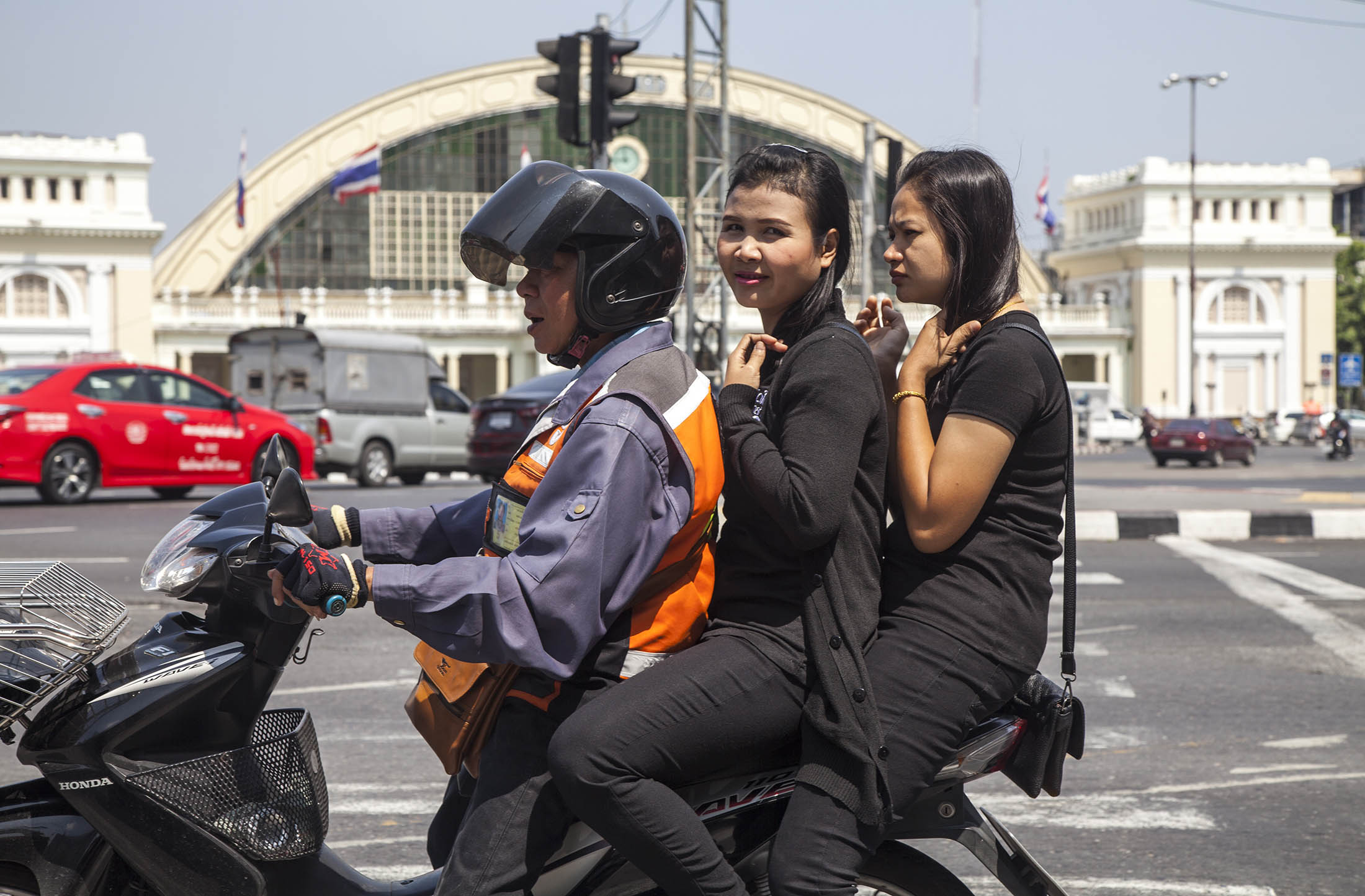 People on a scooter in Bangkok, Thailand