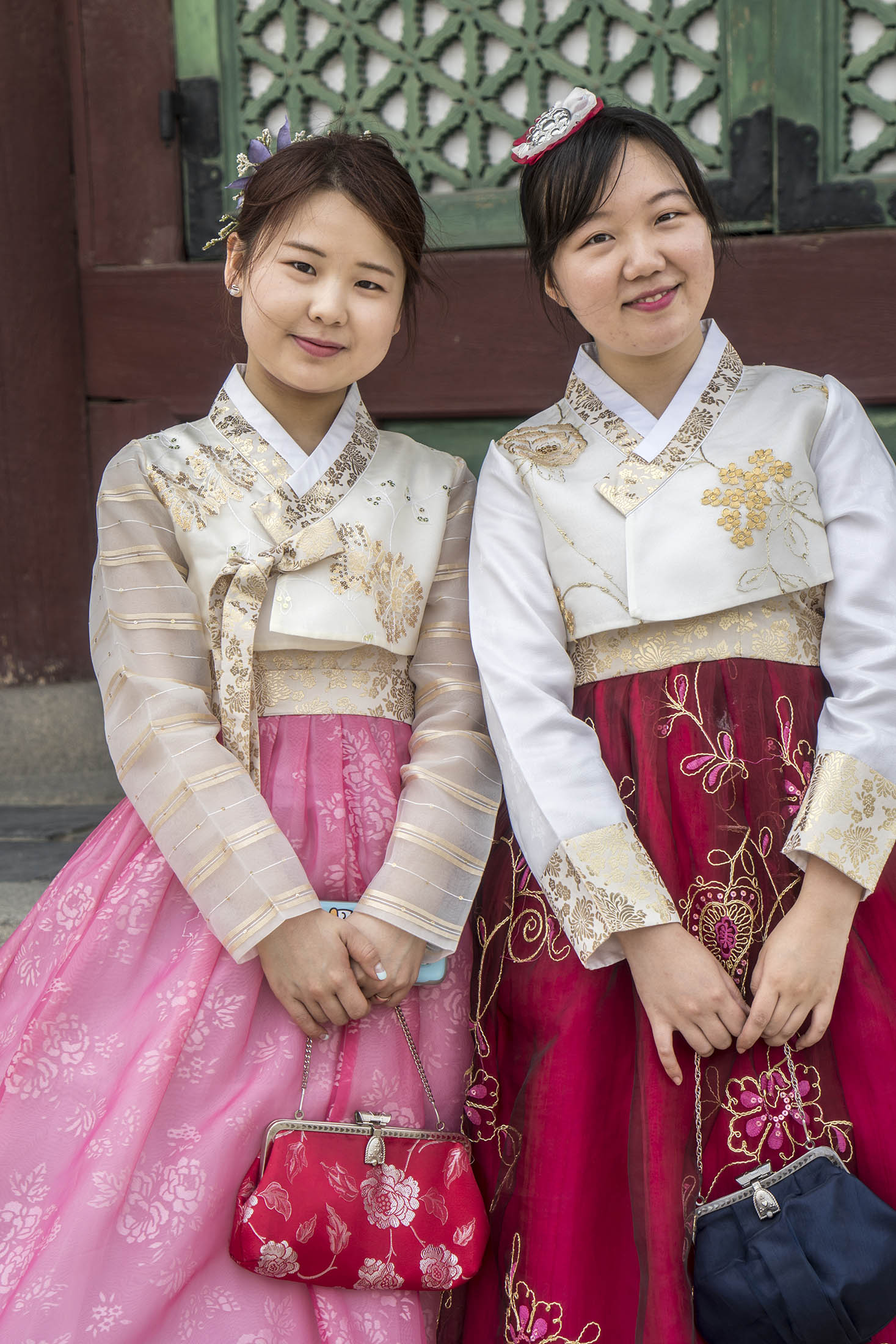 Two young women in traditional clothing posing in Seoul, South Korea