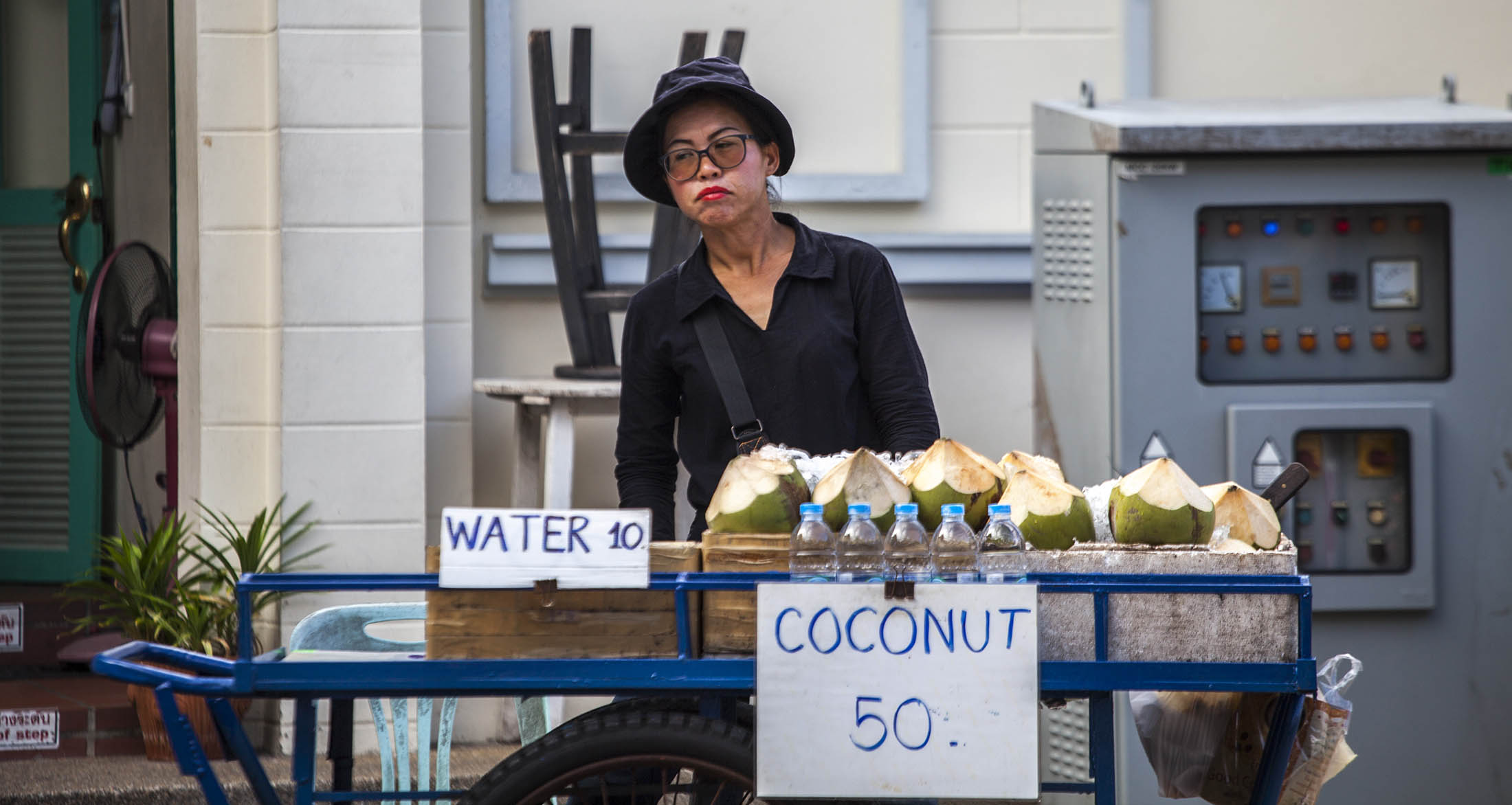 Woman selling coconuts in Bangkok, Thailand